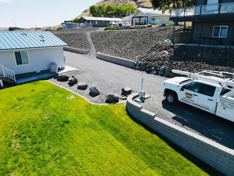 Dircio's Landscaping truck beside a finished lawn and block retaining wall