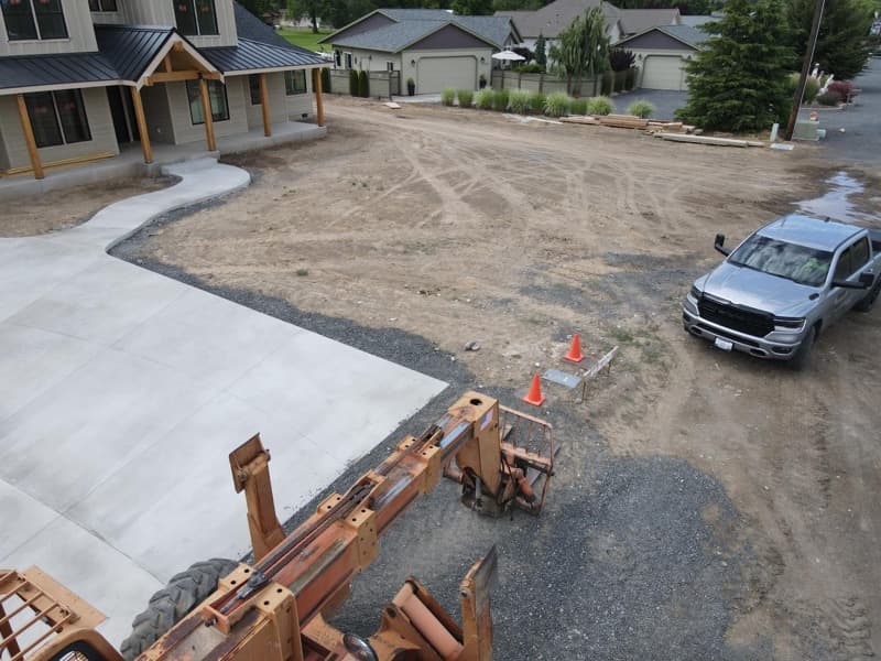 New concrete driveway poured beside a home