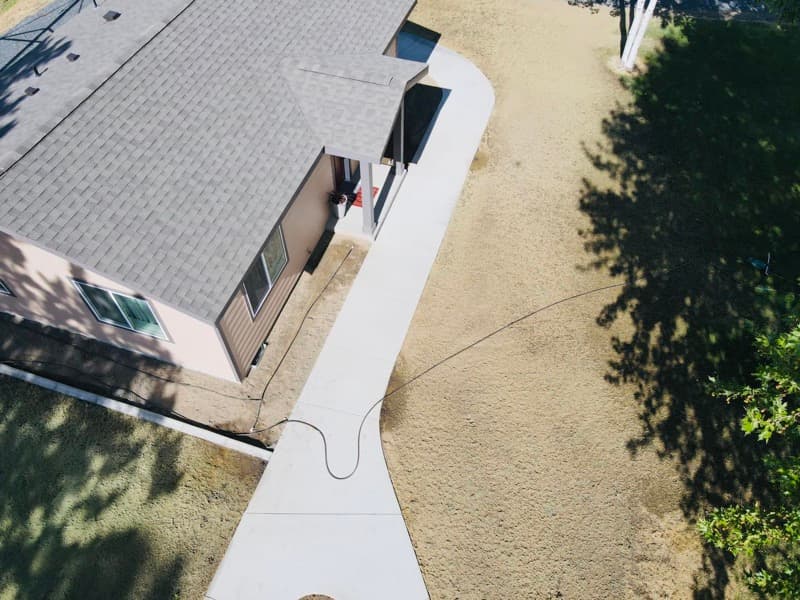 New concrete walkway along the side of a home