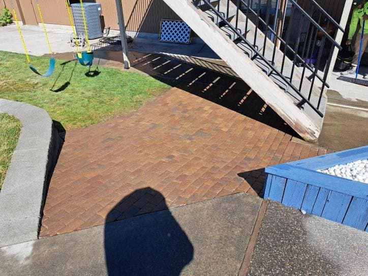 Stamped concrete patio with concrete curbing around a lawn