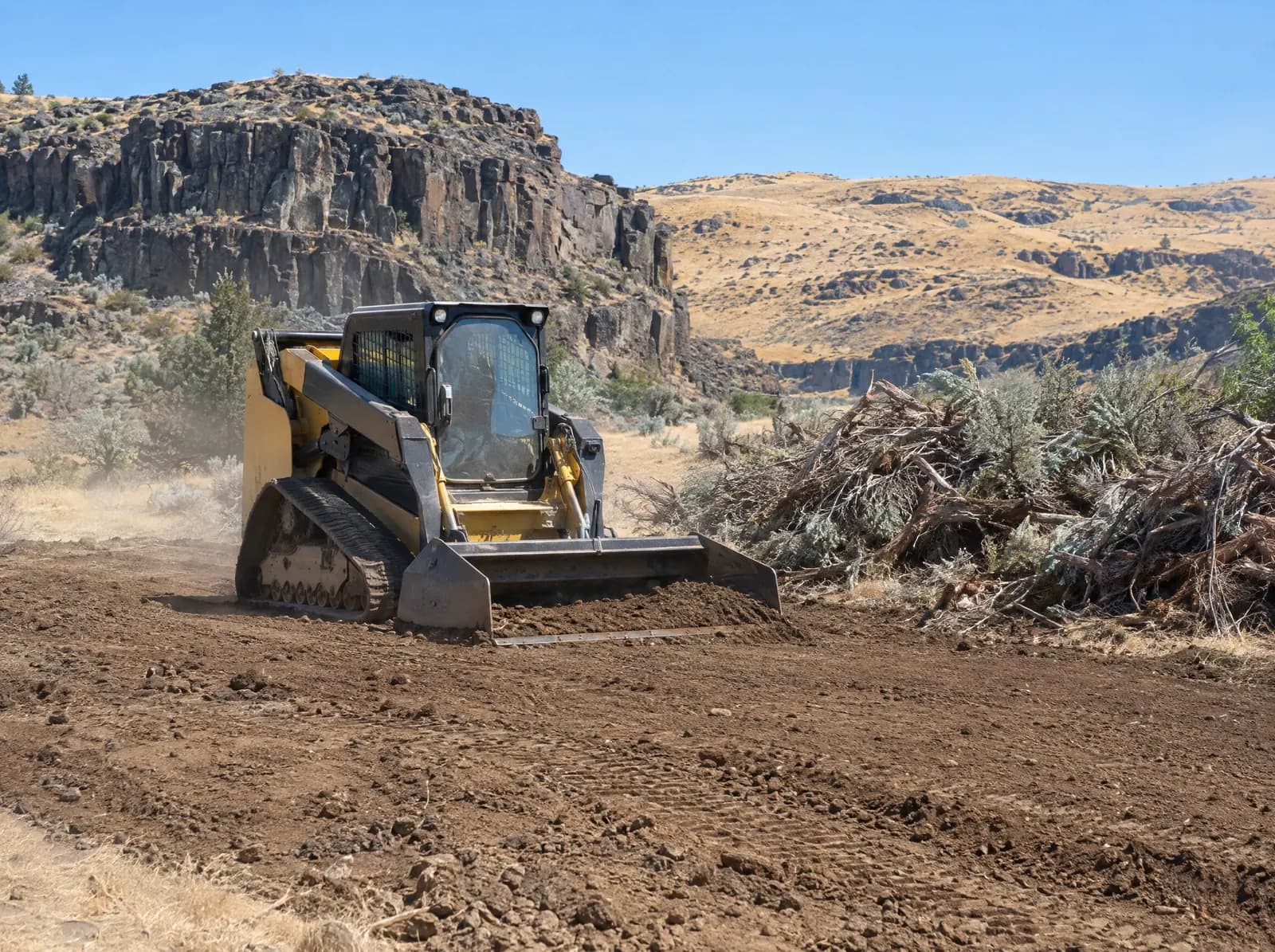 Track loader leveling a cleared rural lot