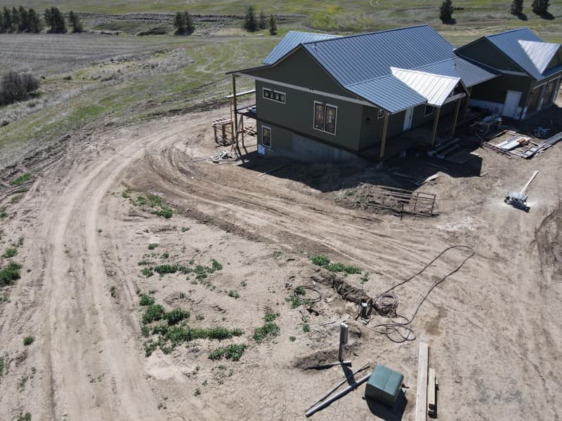 Aerial view of a new home's yard before grading and landscaping