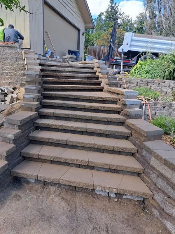 Long paver staircase built into a sloped yard