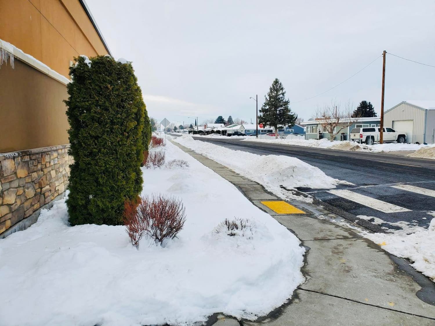 Snow cleared from a commercial sidewalk and crosswalk
